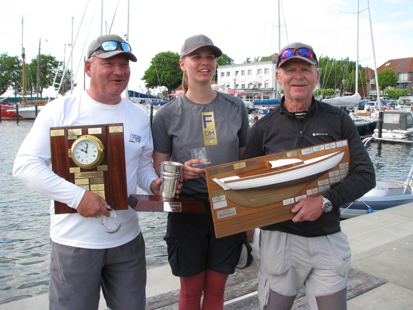 Die erfolgreiche  dänische Crew v.l.: Jens Thurøe, Petra Jørs und Knud Peder Andersen mit dem Trudelmaus-Halbmodell, der Glasenuhr für den besten auswärtigen Steuermann und dem Pokal für die beste dänische Crew.